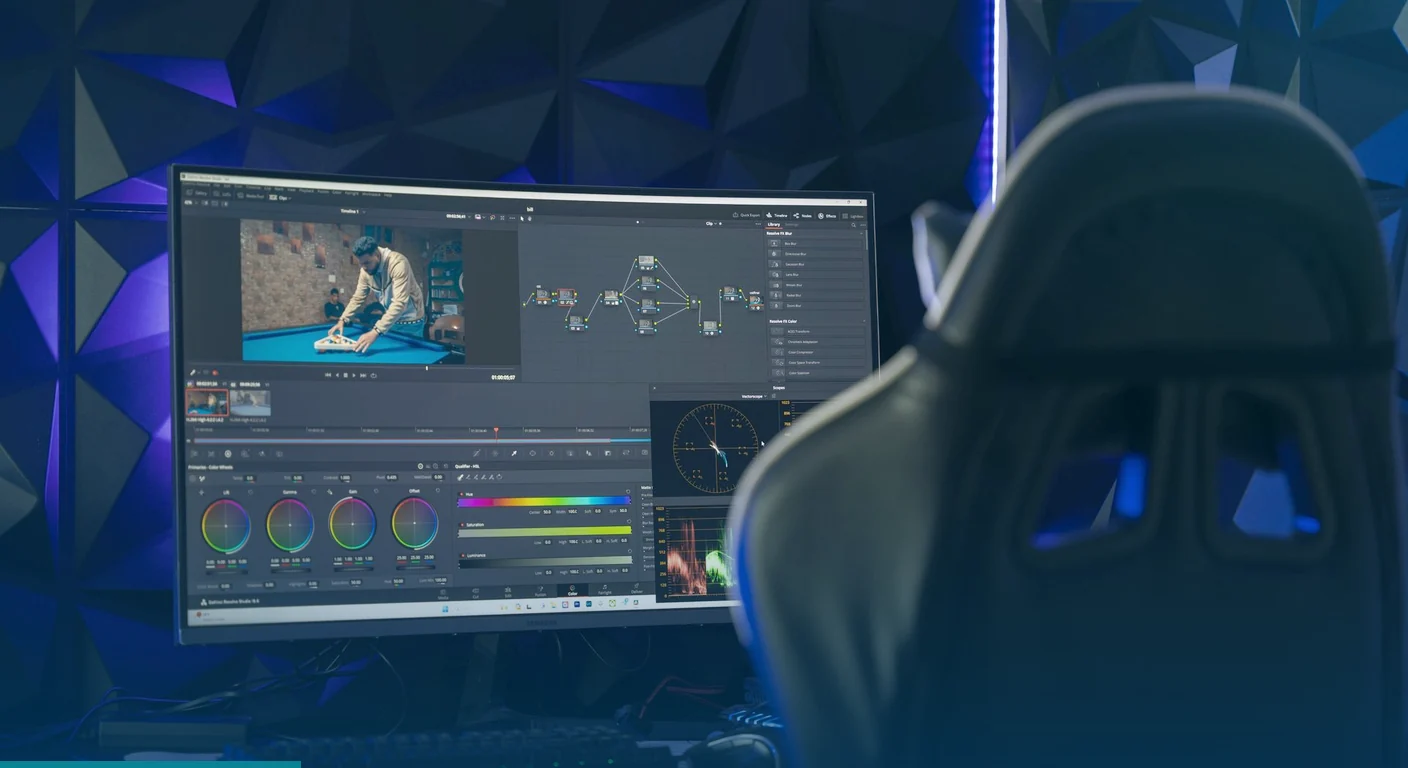 Video editing suite with color grading software on a monitor and a gaming chair