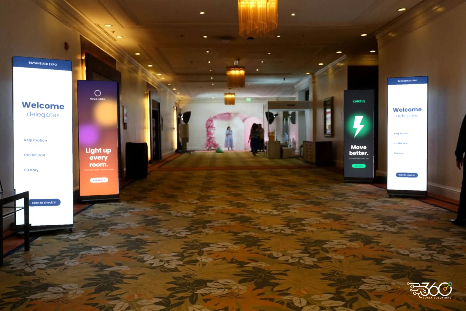 LED Posters lining a hotel hallway, showing welcome and event directory screens on the way to the registration area