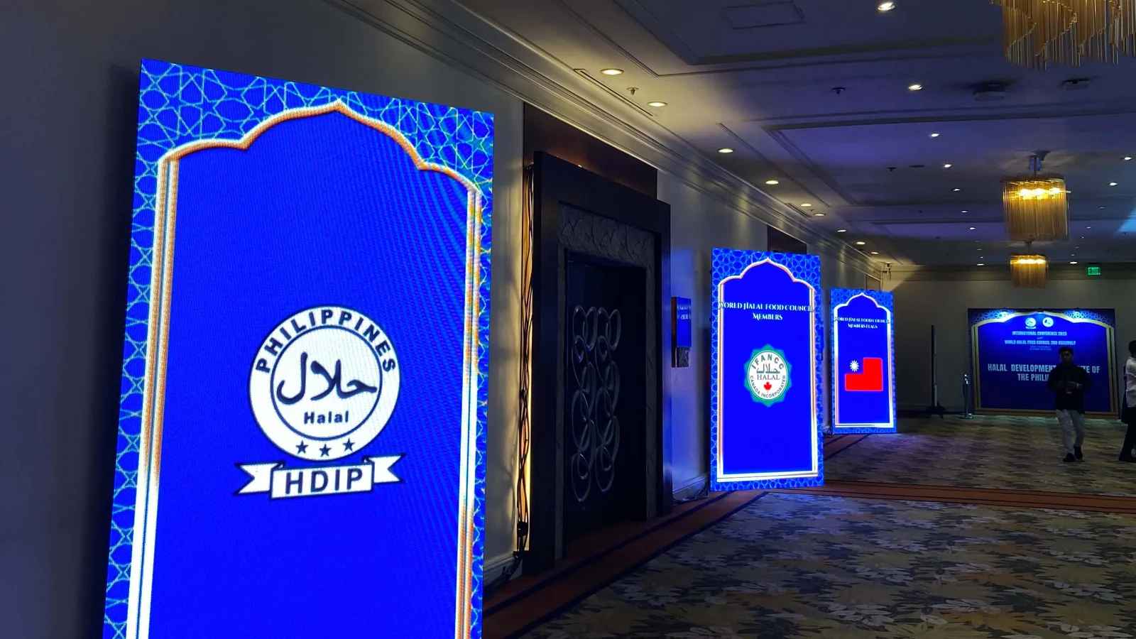 Lit LED Posters standing along a hotel event hallway