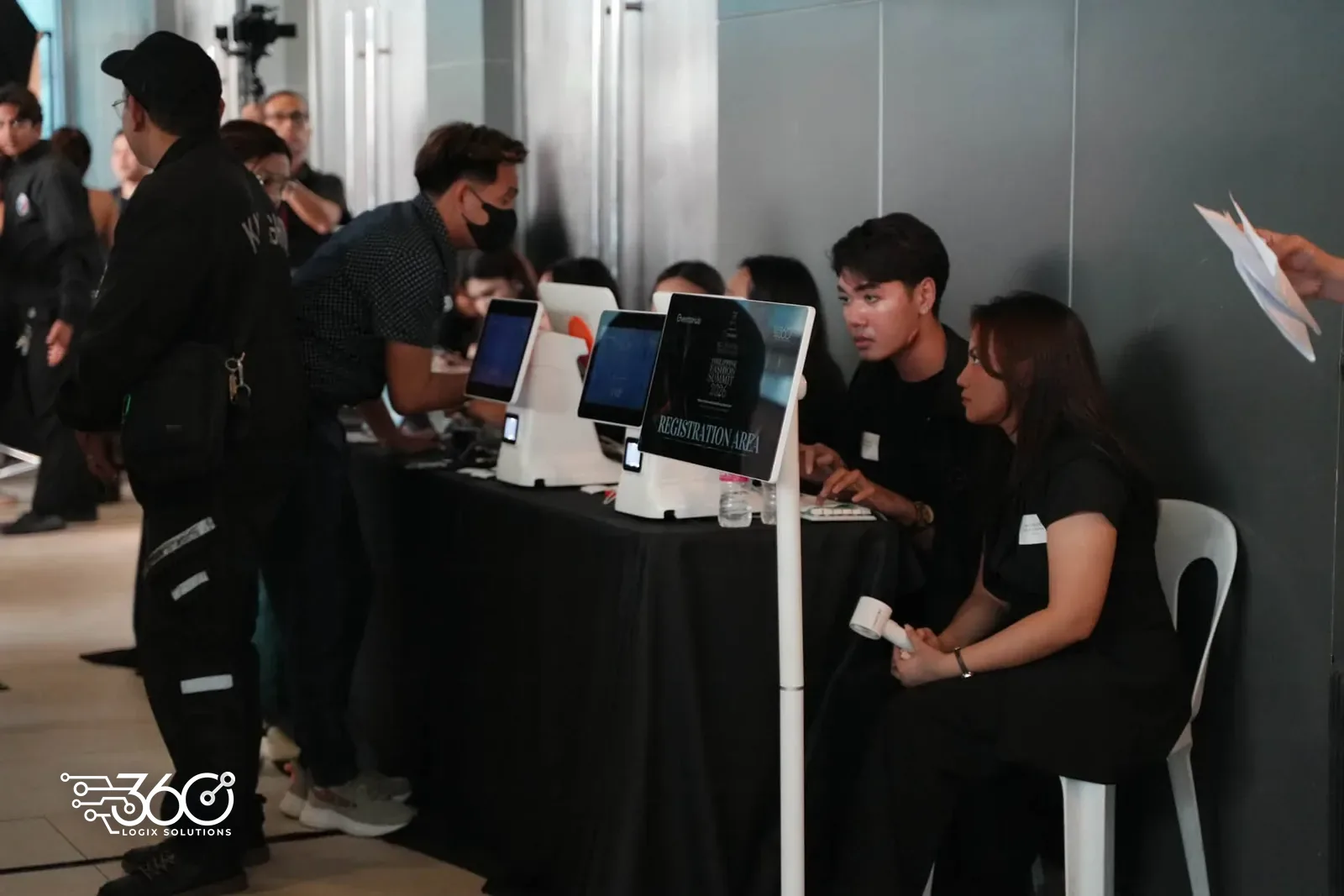 Guests using self check-in kiosks at the 9th Philippine Fashion Summit, with our staff on hand at the registration counter