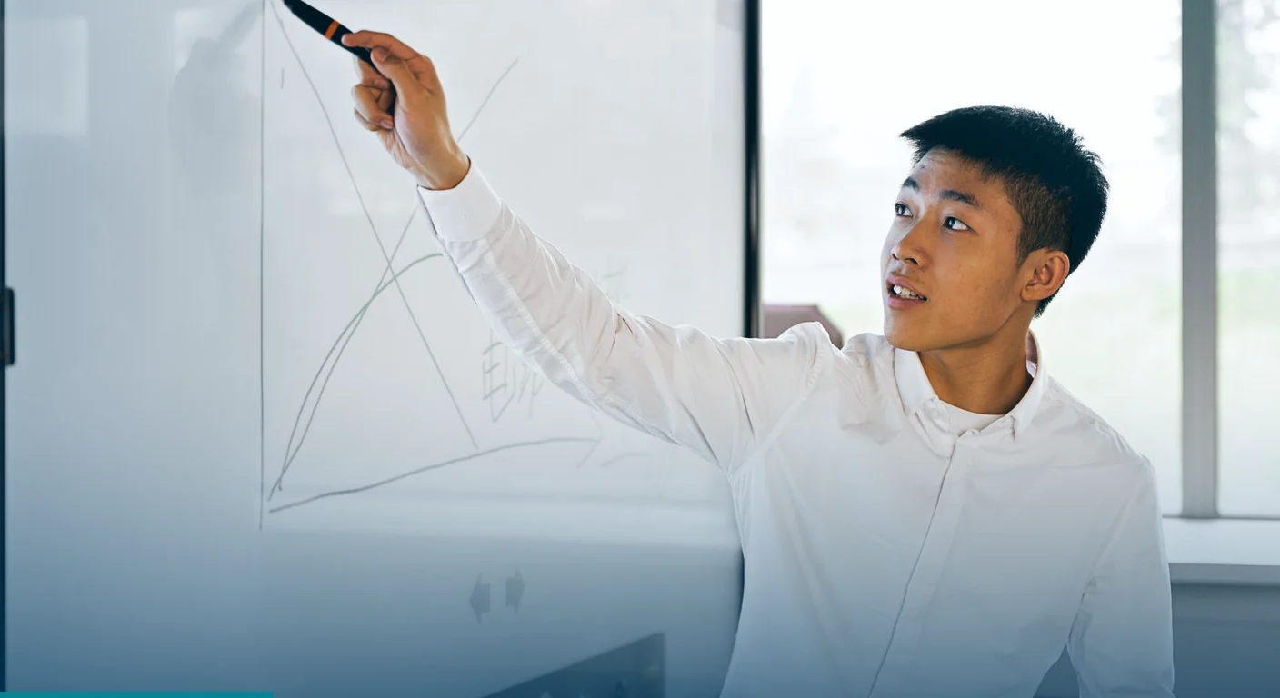 Presenter drawing on a large interactive display board