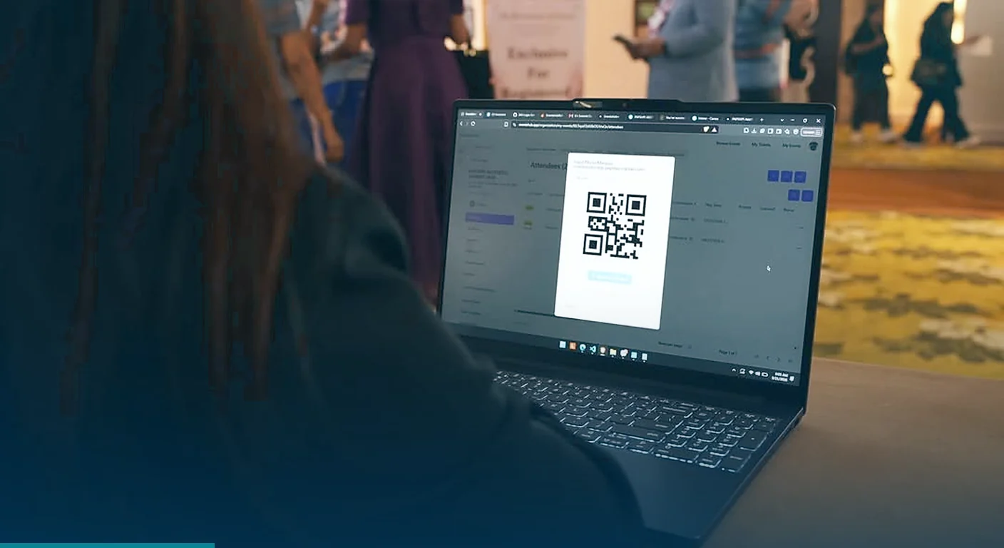 QR code check-in system on a laptop at a busy event entrance, set up by 360 Logix