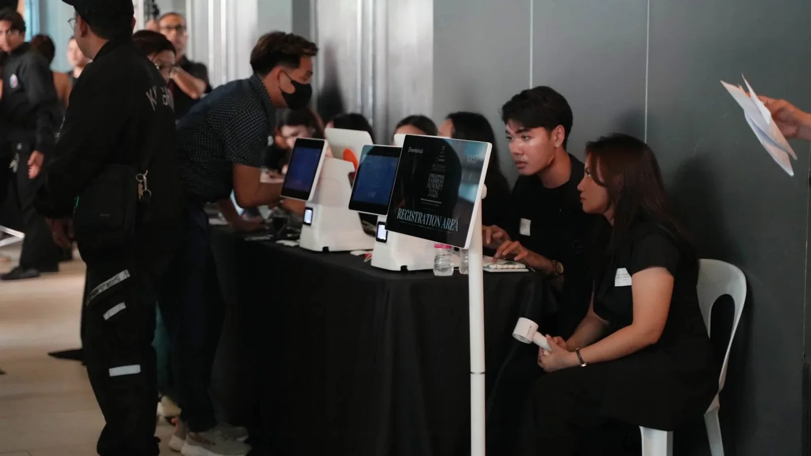 Event registration area with check-in kiosks, a smart display and registration staff