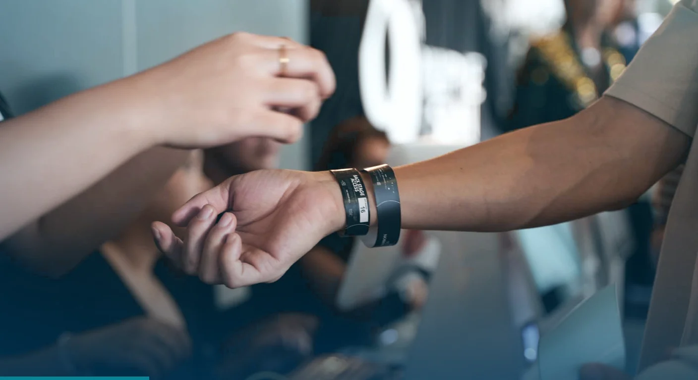 Event registration system in the Philippines at check-in, with a guest receiving an access wristband