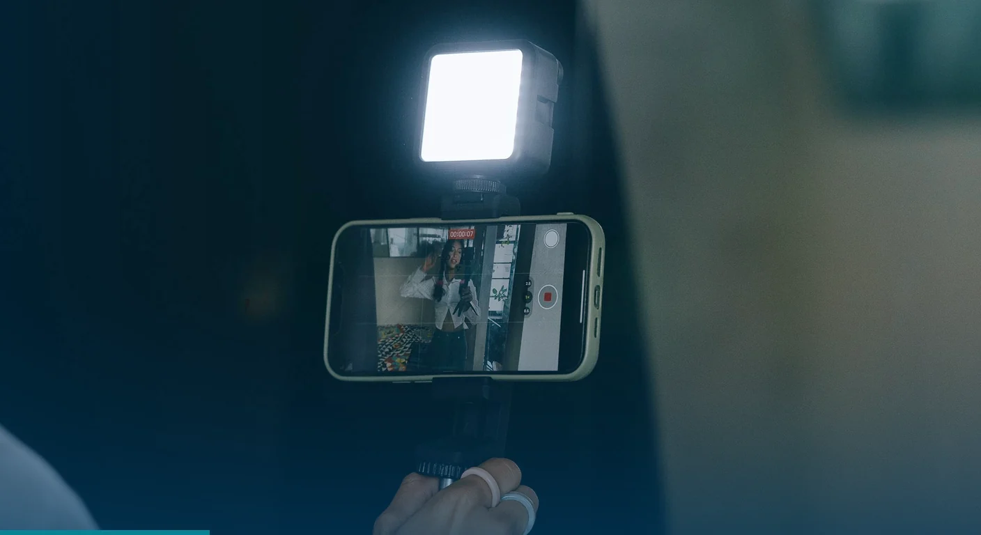 Phone on a handheld rig with an LED light recording short video content for digital marketing services in the Philippines