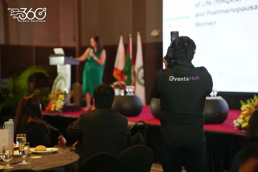 Video coverage by 360 Logix at the UP College of Medicine Grand Scientific Symposium, with a speaker on stage