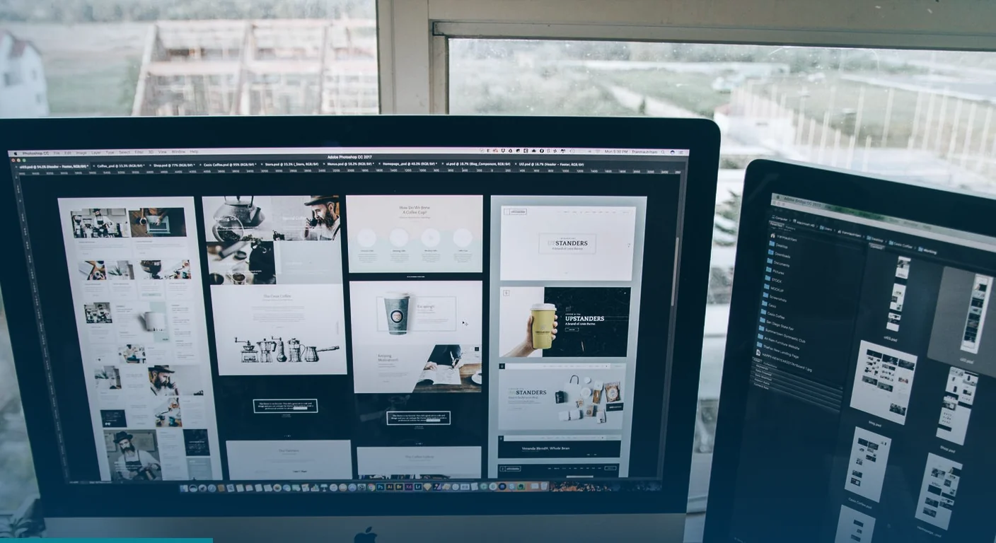 Website page layouts open on two desktop screens